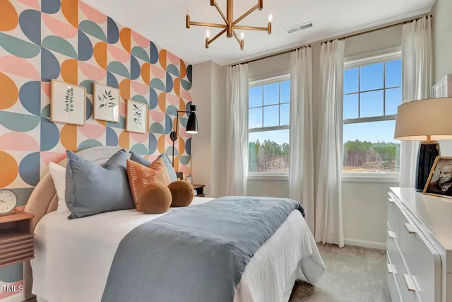 a bedroom with a bed and a view of kitchen