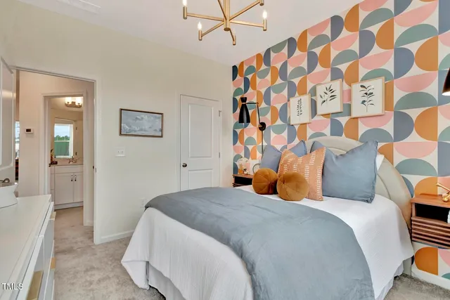 a bedroom with a bed and painting on the wall