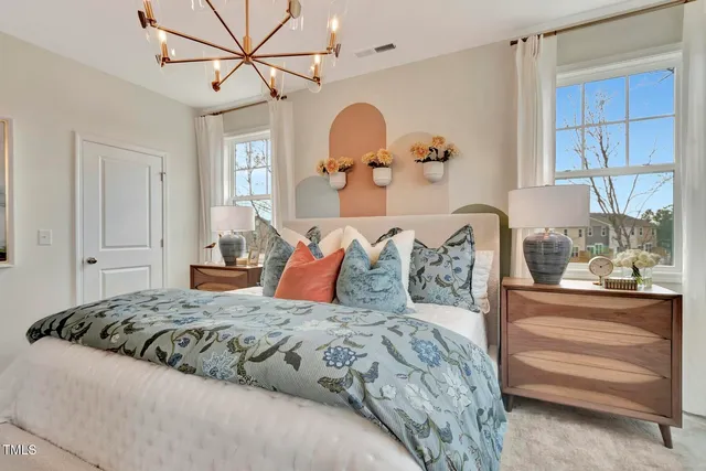 a bedroom with a bed and a chandelier