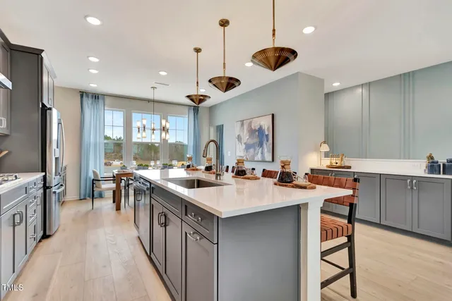 a kitchen with counter space a sink appliances and cabinets