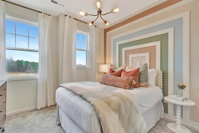 a bedroom with a large bed and a window