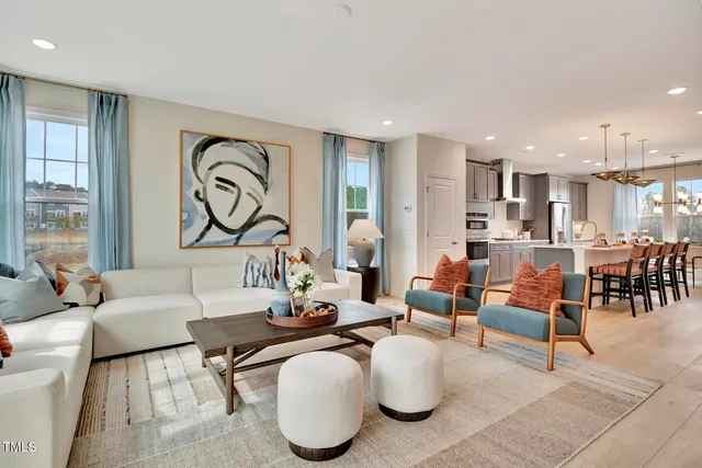 a living room with furniture and kitchen view