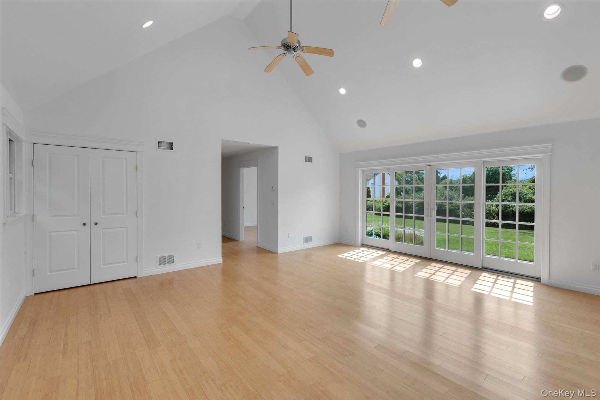 1155 Tasker Lane Greenport, NY 11944 - Photo 14 of 25 Unfurnished living room with high vaulted ceiling, recessed lighting, light wood-style floors, and ceiling fan