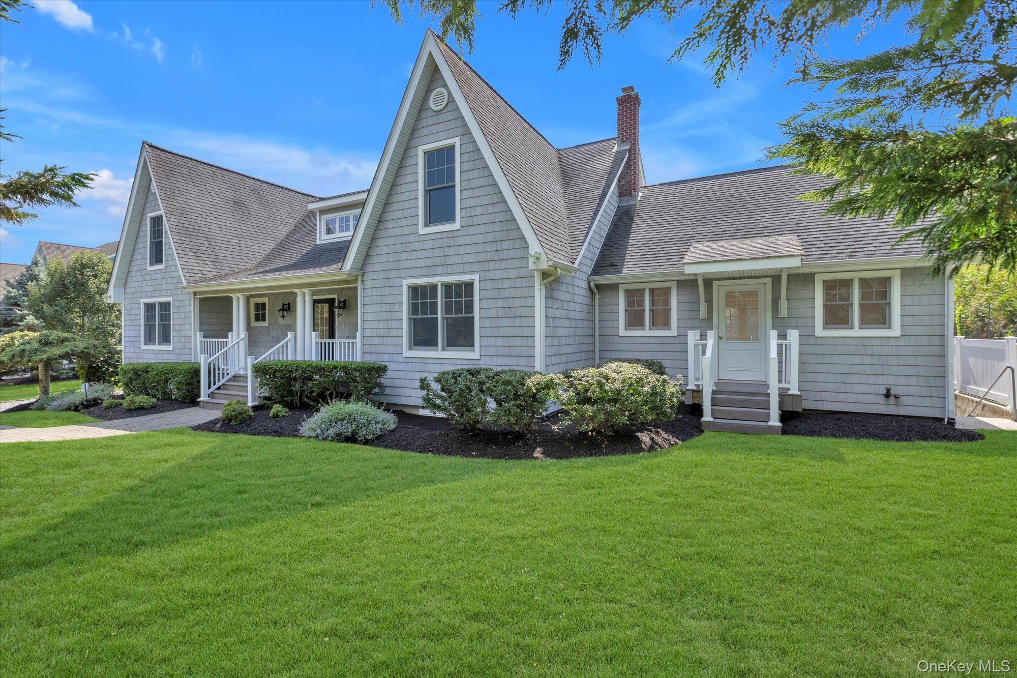1155 Tasker Lane Greenport, NY 11944 - Photo 24 of 25 View of front of house featuring roof with shingles, a front yard, and a chimney