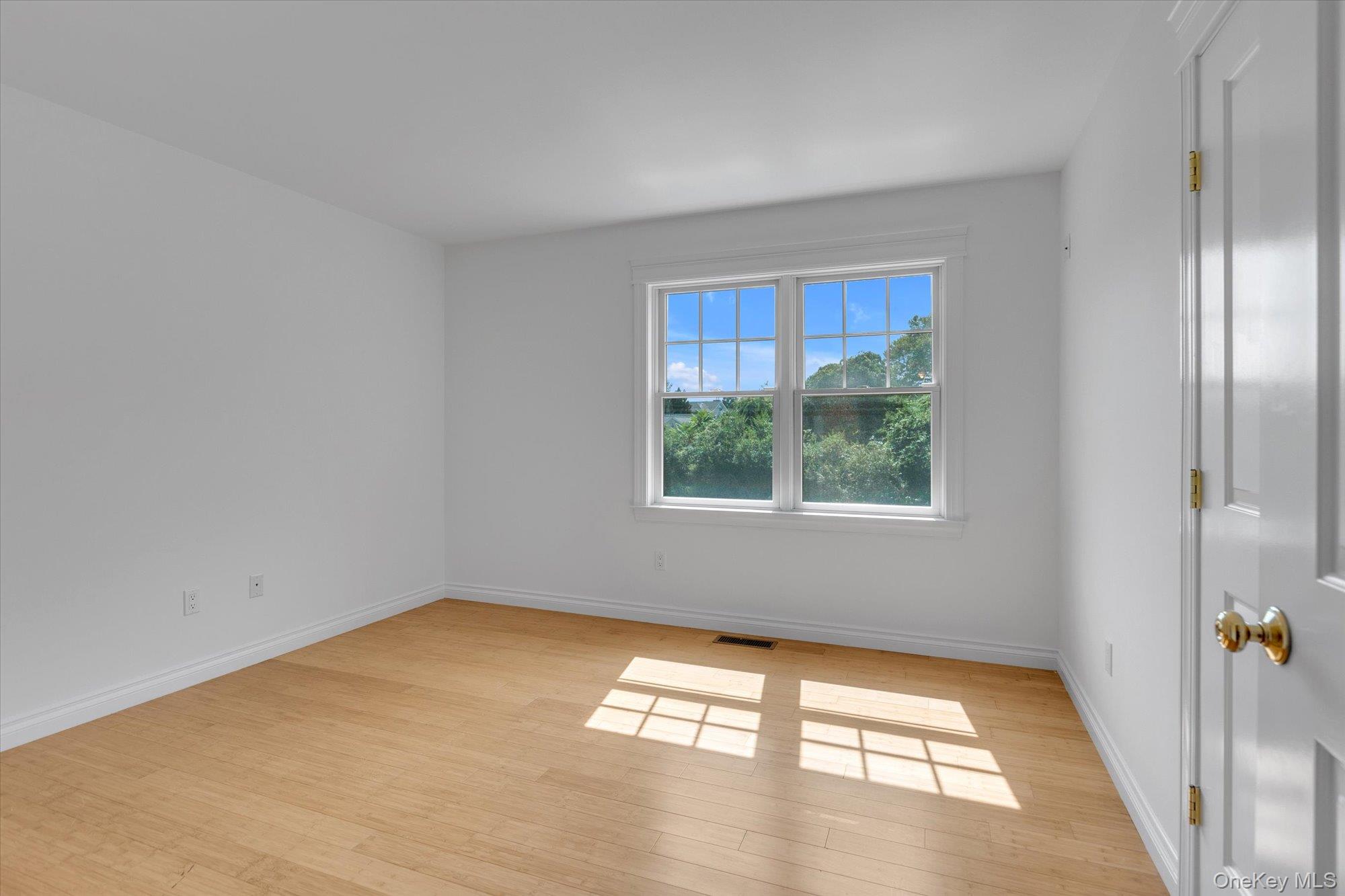 1155 Tasker Lane Greenport, NY 11944 - Photo 10 of 25 Empty room featuring baseboards and light wood-type flooring