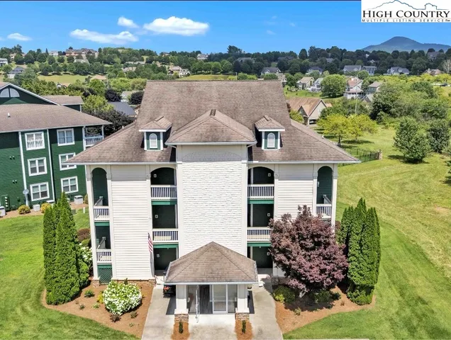 a aerial view of a house next to a yard