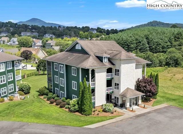 a aerial view of a house with yard and patio