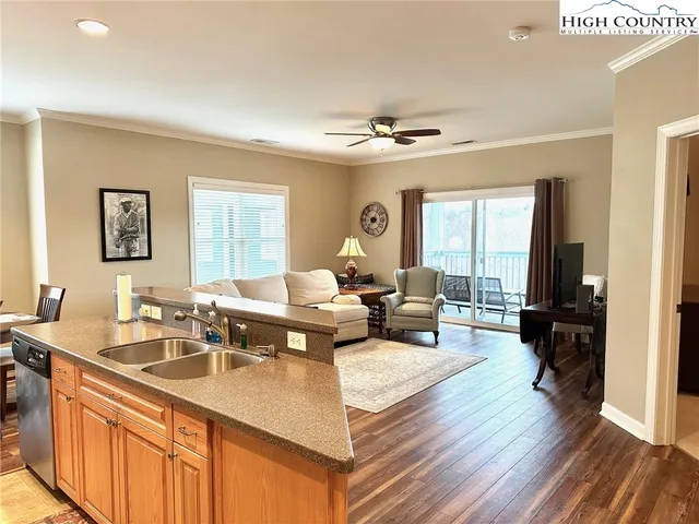 a living room with furniture flat screen tv and window