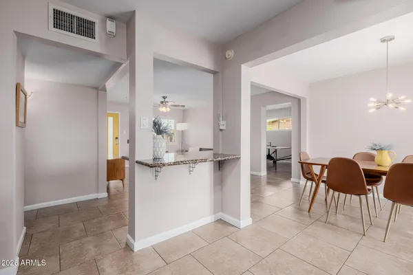 a kitchen with stainless steel appliances kitchen island granite countertop a refrigerator and a sink