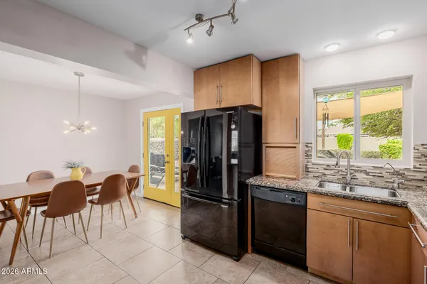 a kitchen with granite countertop white cabinets and stainless steel appliances