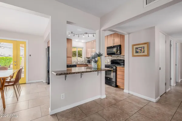 a kitchen with stainless steel appliances a stove sink and microwave