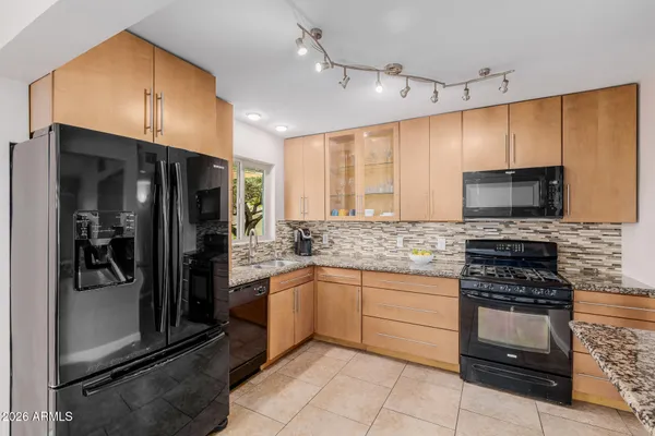 a kitchen with refrigerator and window