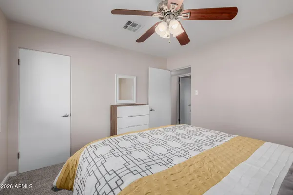 a bedroom with a bed and cabinets
