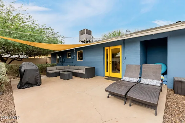 a view of a house with pool and a yard