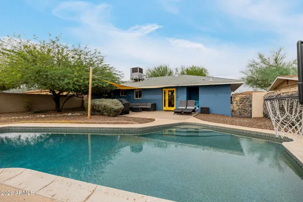 a view of a swimming pool with a yard