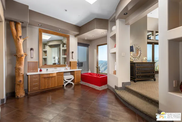 a bedroom with a bed couch and a flat tv screen