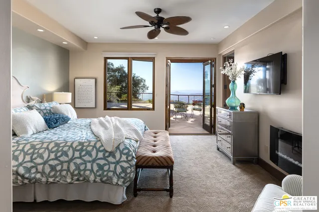 a view of a balcony with two chairs and a potted plant