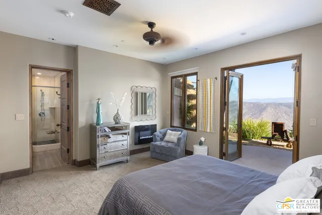 an outdoor living room with furniture and a fireplace