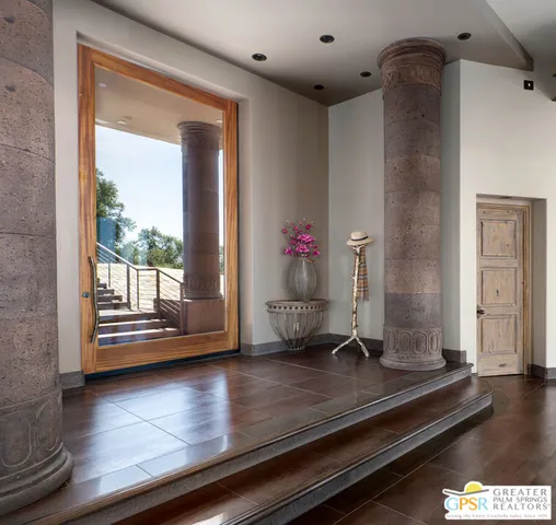 a lobby with furniture and floor to ceiling windows