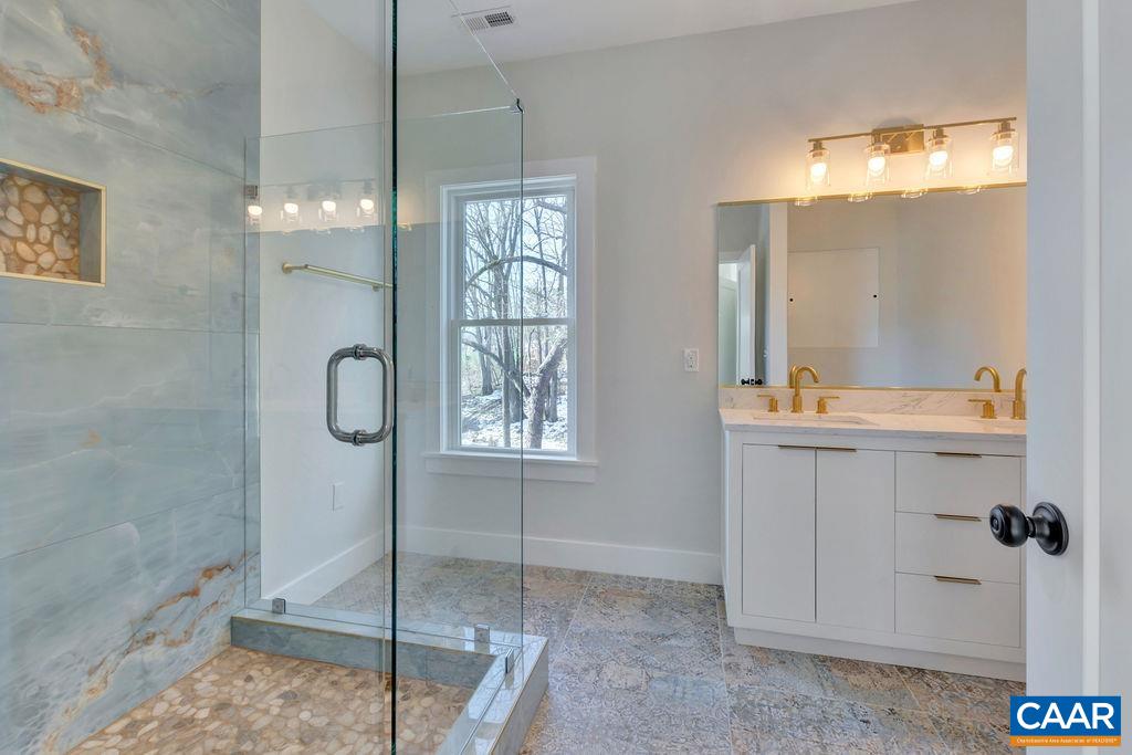 97 Daddy Rabbit Court Ruckersville, VA 22968 - Photo 36 of 48 a bathroom with a shower sink and mirror