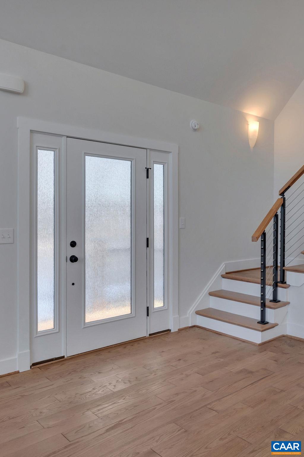 97 Daddy Rabbit Court Ruckersville, VA 22968 - Photo 9 of 48 a view of an entryway with wooden floor and mirror