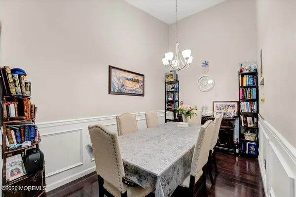 a view of a dining room with furniture and a book shelf
