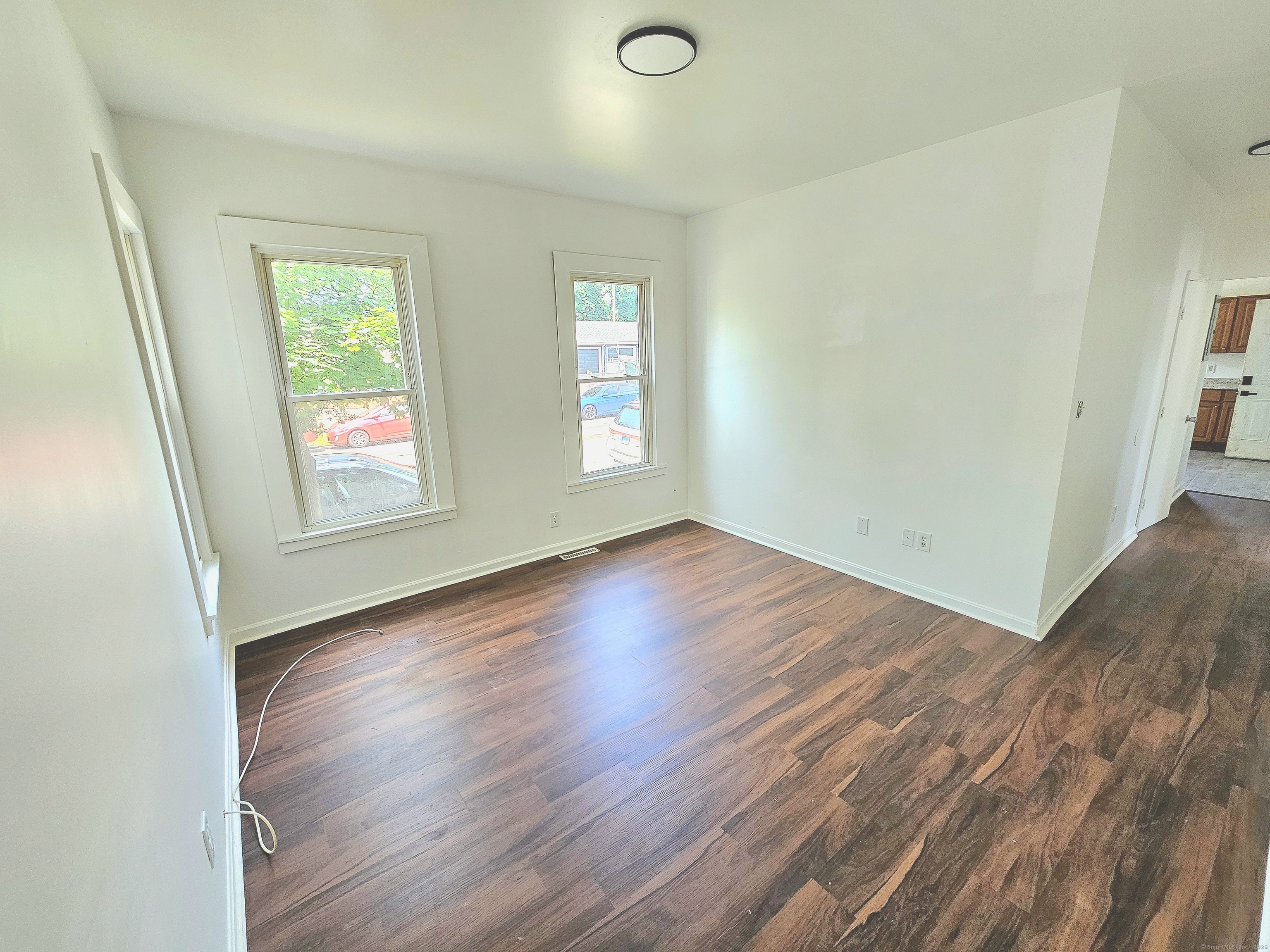483 Ferry Street, Unit 1 New Haven, CT 06513 - Photo 4 of 8 an empty room with wooden floor and windows