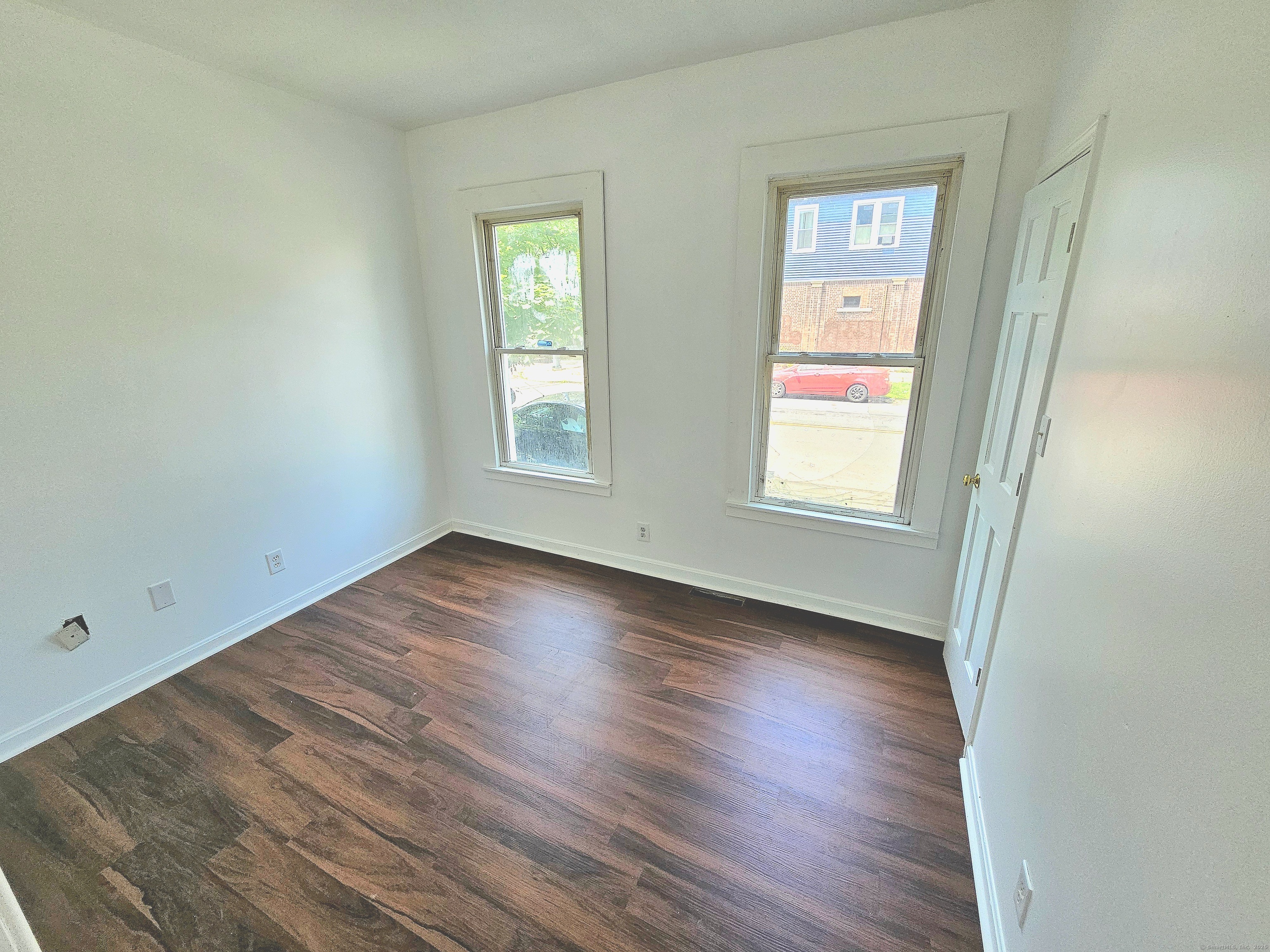 483 Ferry Street, Unit 1 New Haven, CT 06513 - Photo 5 of 8 an empty room with wooden floor and windows