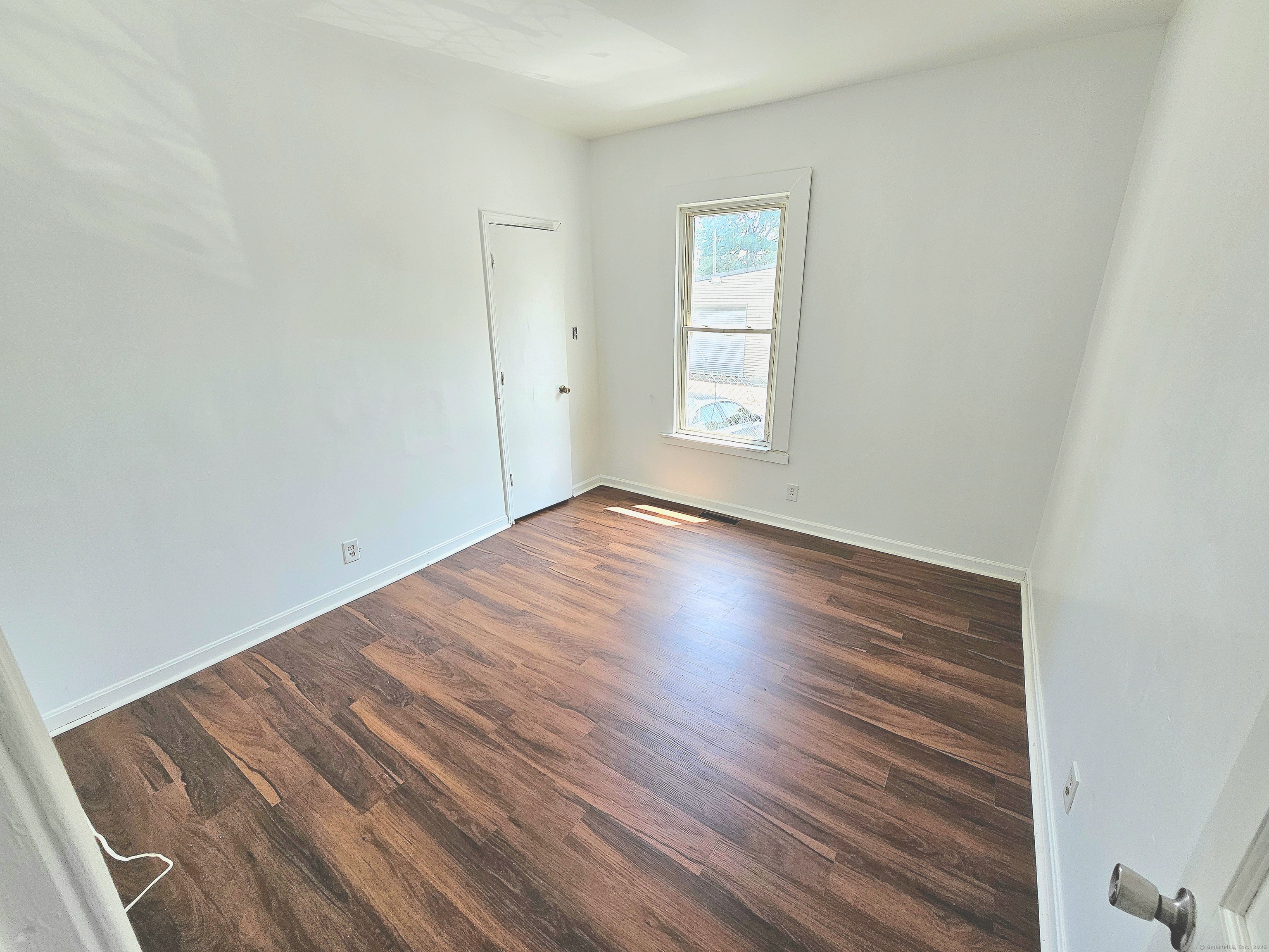 483 Ferry Street, Unit 1 New Haven, CT 06513 - Photo 6 of 8 an empty room with wooden floor and windows