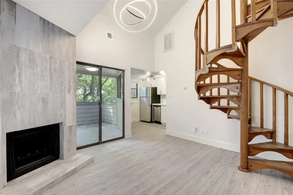 wooden floor in an empty room with a fireplace