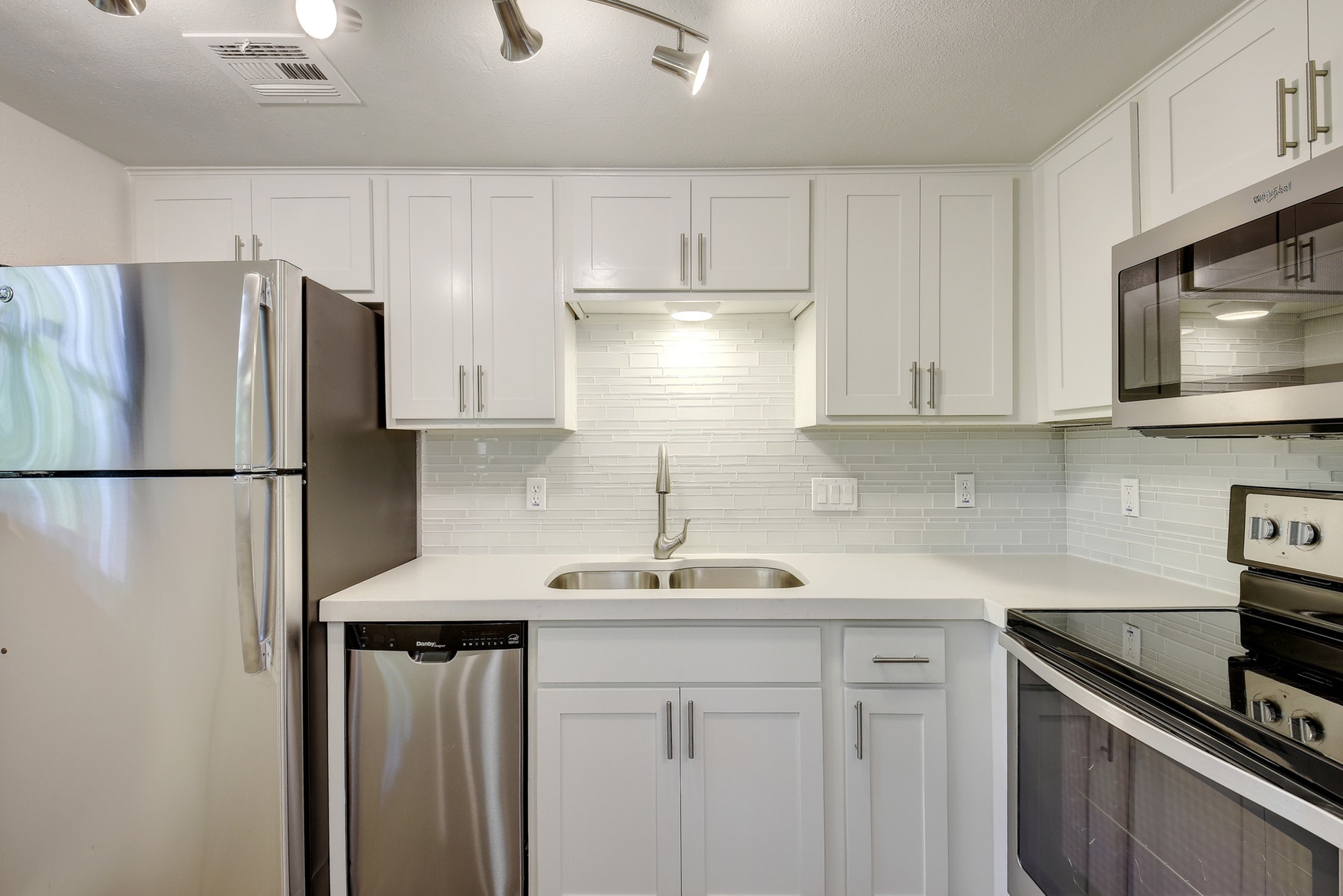 2500 Burleson Road, Unit 719 Austin, TX 78741 - Photo 12 of 22 a kitchen with stainless steel appliances granite countertop a refrigerator sink and microwave