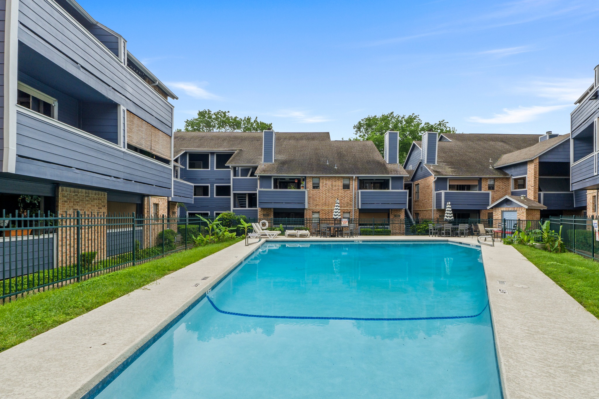 2500 Burleson Road, Unit 719 Austin, TX 78741 - Photo 20 of 22 a view of a house with pool fire pit a yard and a large tree