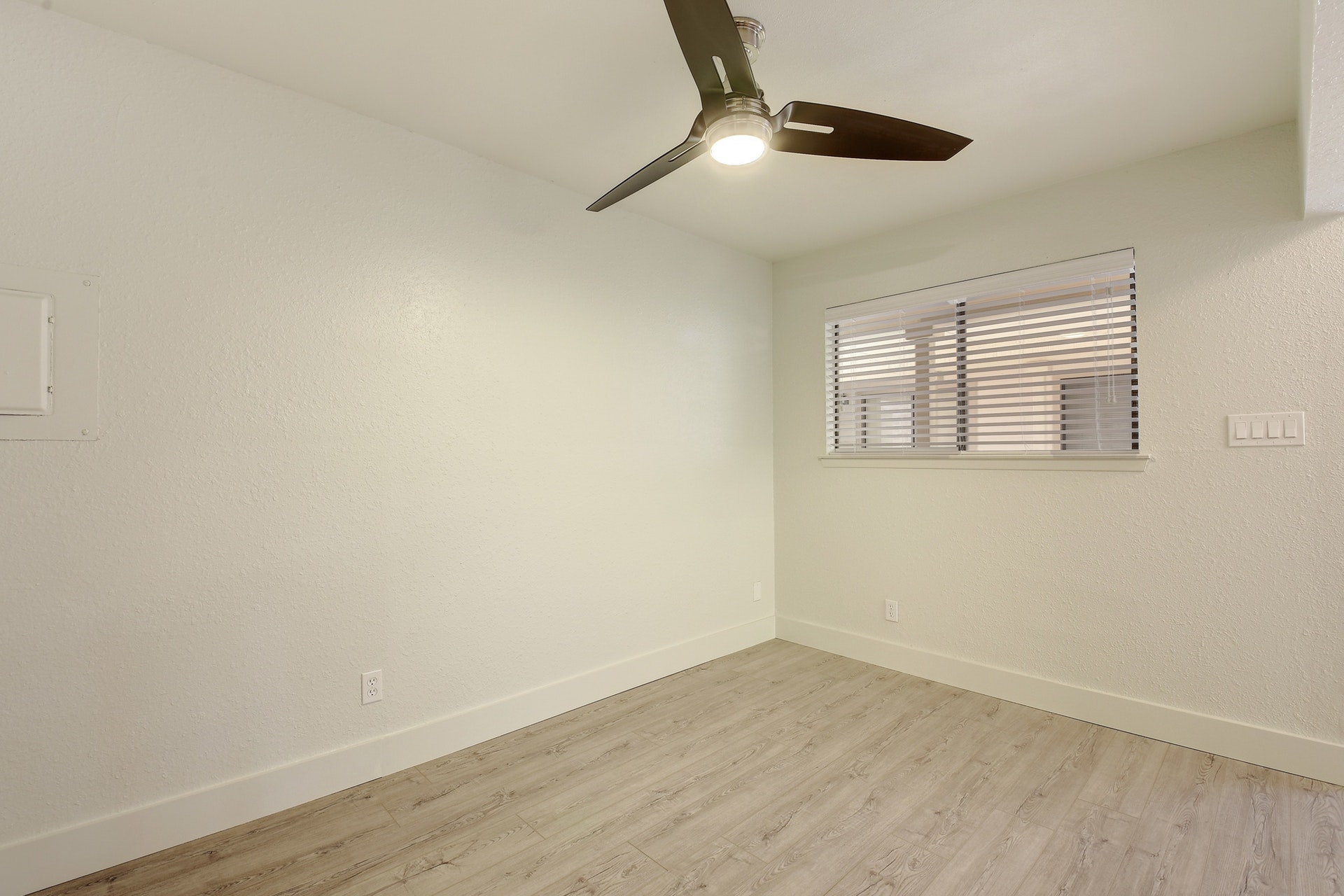 2500 Burleson Road, Unit 719 Austin, TX 78741 - Photo 8 of 22 an empty room with wooden floor fan and windows