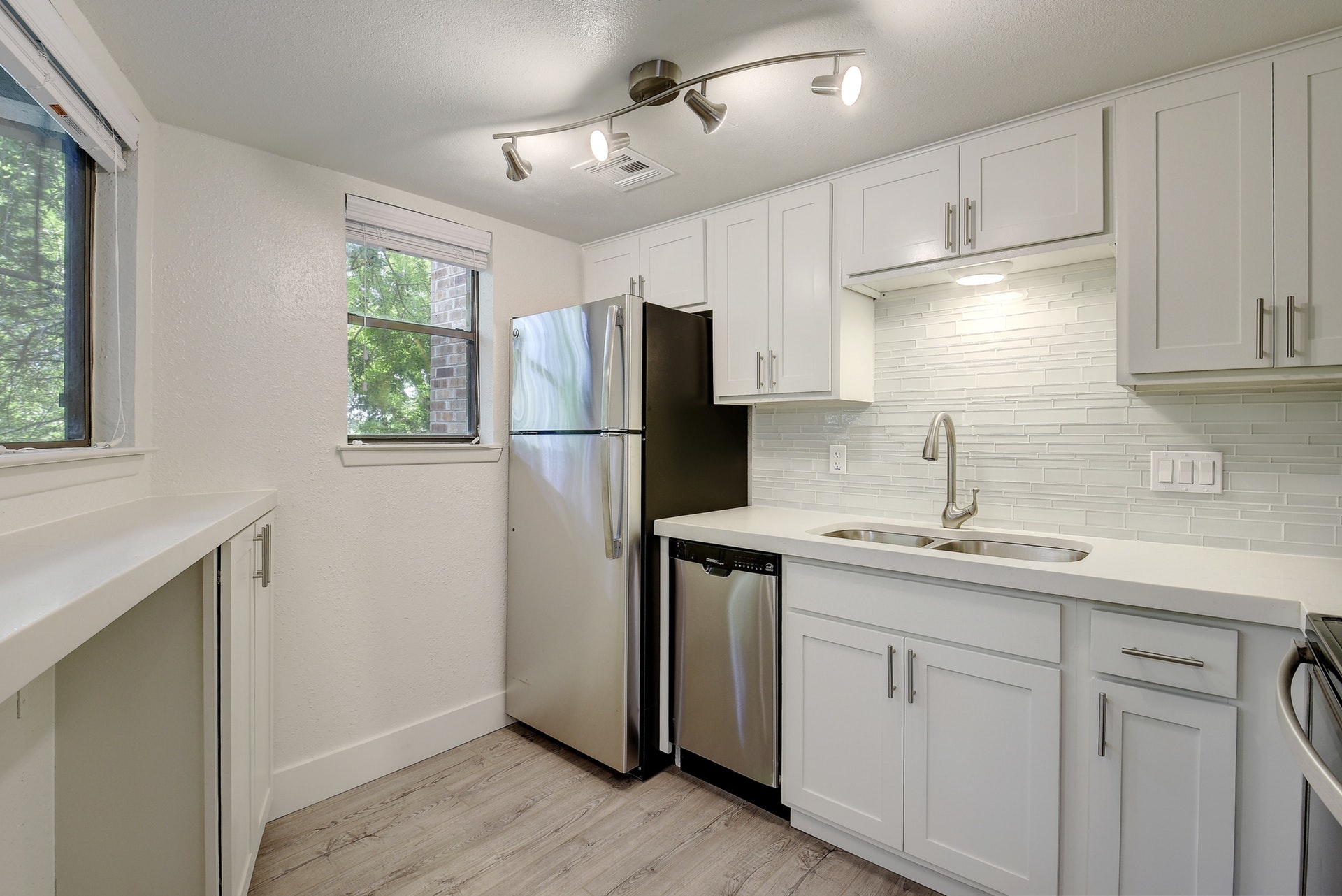 2500 Burleson Road, Unit 719 Austin, TX 78741 - Photo 10 of 22 a kitchen with a sink cabinets stainless steel appliances and a window