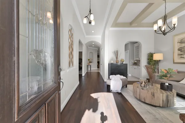a living room with furniture and a chandelier