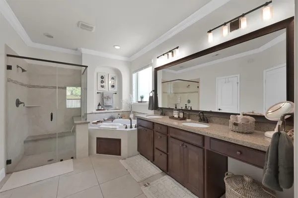 a bathroom with a sink double vanity and shower