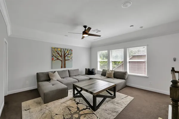 a living room with furniture a window and a table