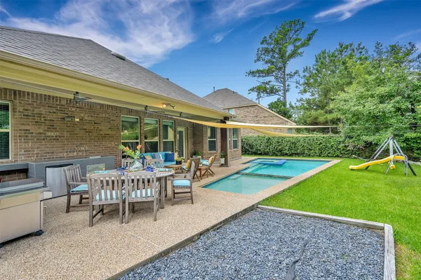 a view of a house with backyard porch and sitting area