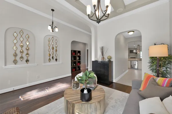 a living room with furniture chandelier and a chandelier