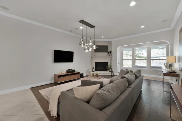 a living room with furniture a flat screen tv and a fireplace