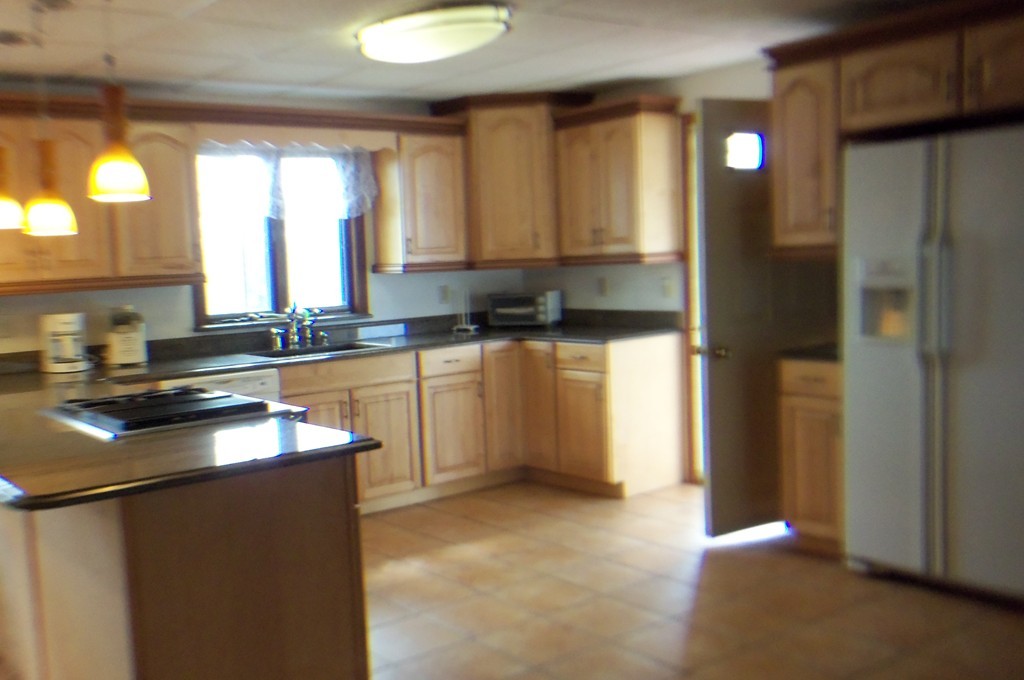 111 Anthony Fall River Fall River, MA 02721 - Photo 13 of 19 a kitchen with stainless steel appliances granite countertop a sink stove and refrigerator