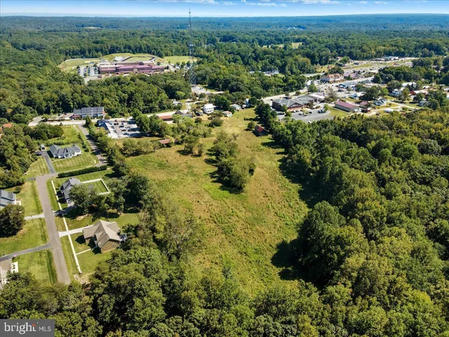 an aerial view of residential house with outdoor space and trees