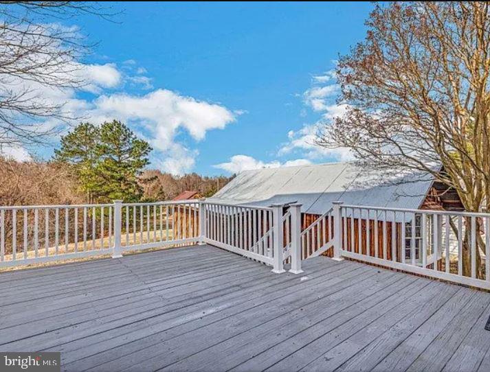 4090 Old Town Road Huntingtown, MD 20639 - Photo 4 of 42 a view of a deck with wooden floor and fence