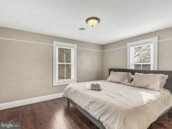 a bedroom with a large bed and a window
