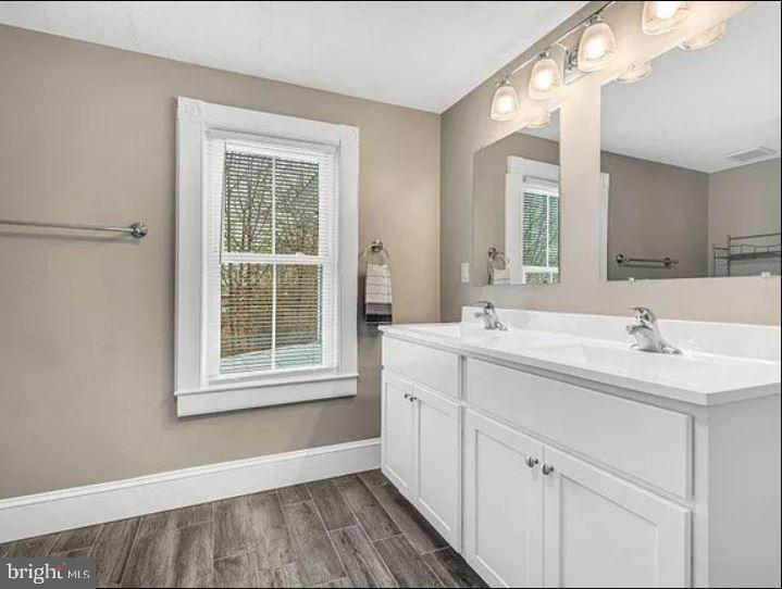 4090 Old Town Road Huntingtown, MD 20639 - Photo 10 of 42 a bathroom with a sink mirror and a window