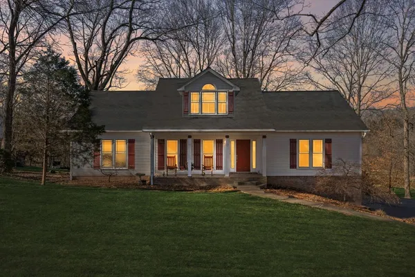 a front view of house with yard and green space
