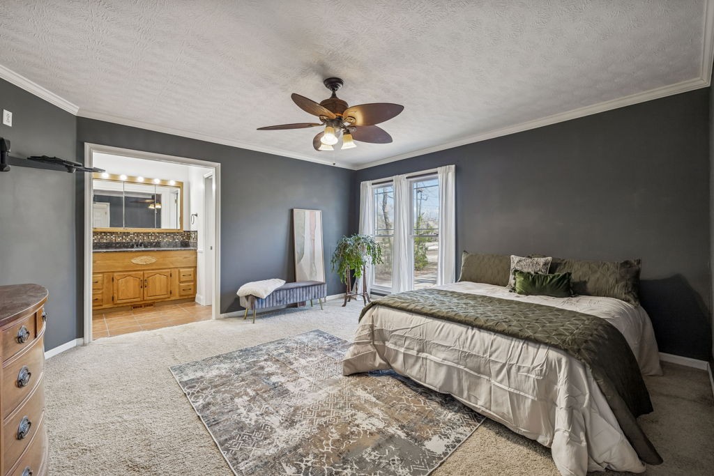 1728 Riverhaven Drive Adams, TN 37010 - Photo 15 of 75 a bedroom with a bed and a chandelier