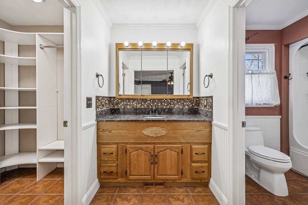 1728 Riverhaven Drive Adams, TN 37010 - Photo 18 of 75 a bathroom with a granite countertop toilet a sink and a mirror