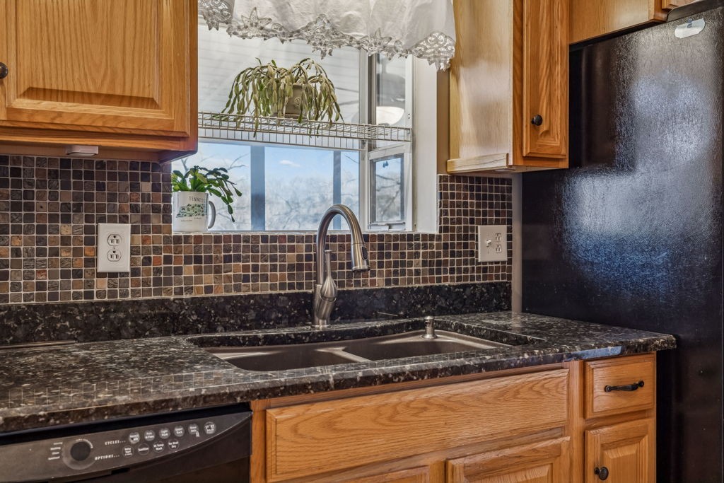 1728 Riverhaven Drive Adams, TN 37010 - Photo 23 of 75 a kitchen with granite countertop a sink a stove and cabinets