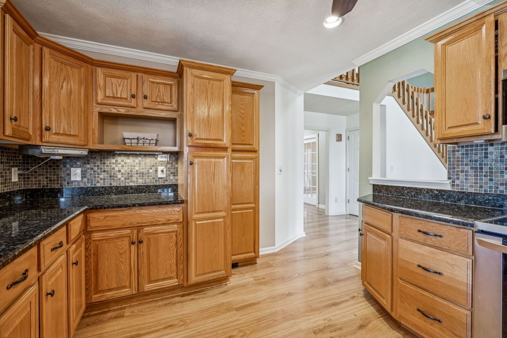 1728 Riverhaven Drive Adams, TN 37010 - Photo 25 of 75 a kitchen with granite countertop a refrigerator sink and cabinets